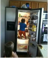 baby getting food from fridge