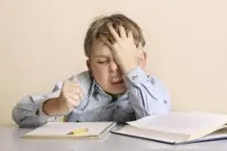 Facepalm studying kid
