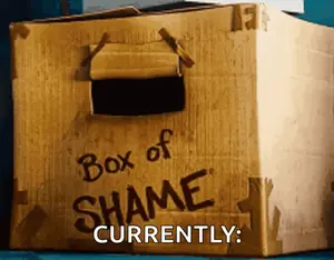 A Cardboard Box That Says " Box Of Shame Currently "