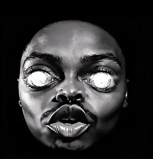 A Black And White Photo Of A Man 'S Face With His Eyes Glowing