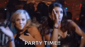 Two Women Are Dancing In A Club And One Of Them Is Saying Party Time !