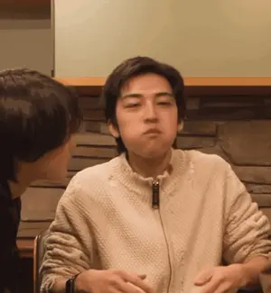 A Man Wearing A White Sweater With A Zipper On The Front