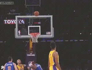 A Basketball Player For The Lakers Throws The Ball