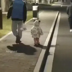 A Man And A Little Girl Are Walking Down A Sidewalk With Hangseed Written On The Bottom Of The Image