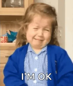 A Little Girl Is Crying And Smiling While Wearing A Blue Jacket And A Plaid Shirt .