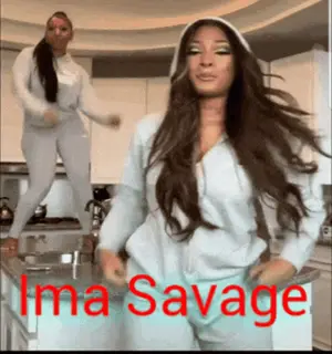 Two Women Are Dancing In A Kitchen With The Name Ima Savage Written On The Bottom