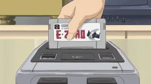 A Hand Is Inserting A Super Nintendo Cartridge Into A Video Game Console