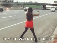 A Woman In A Red Dress Is Dancing On The Sidewalk .