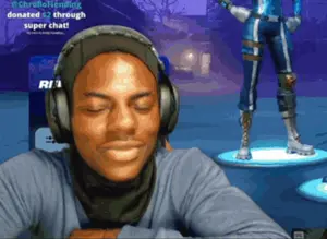 A Man Wearing Headphones Is Sitting In Front Of A Screen That Says ' @Chrellofriending ' On It