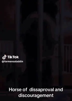 A Man Is Standing In Front Of A Fence With The Words Horse Of Disapproval And Discouragement Written On The Bottom .