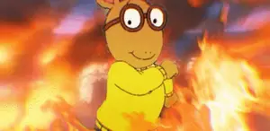 A Cartoon Character With Glasses And A Yellow Sweater Is Standing In Front Of A Fire