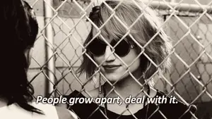 A Woman Wearing Sunglasses Is Behind A Chain Link Fence And Says " People Grow Apart Deal With It "