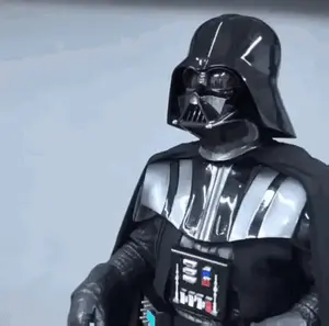 A Person In A Darth Vader Costume Is Standing In Front Of A White Wall .