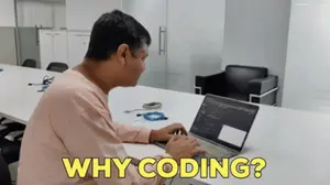 A Man Sitting At A Table With A Laptop And The Words " Why Coding " On The Bottom