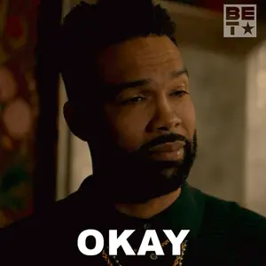 A Man With A Beard Is Making An Okay Sign With His Eyes Closed