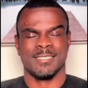 A Close Up Of A Man 'S Face With His Eyes Closed And A Beard .