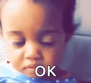 A Close Up Of A Baby 'S Face With The Word Ok Written On It