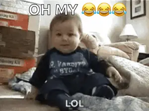 A Baby Is Sitting On A Bed With The Words Oh My Lol Written Above Him