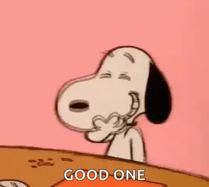 Snoopy Is Sitting At A Table Covering His Mouth With His Hand And Laughing .