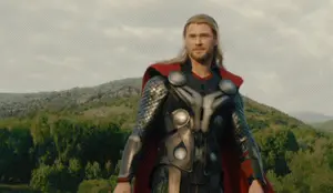 A Man In A Thor Costume Stands In Front Of A Mountain