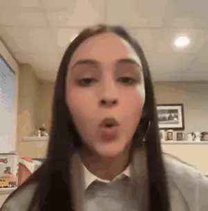 A Close Up Of A Woman Making A Funny Face With Her Mouth Open