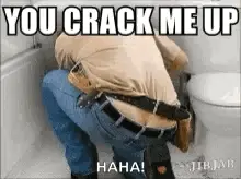 A Man Is Squatting Down In Front Of A Toilet With The Words You Crack Me Up Written On It .