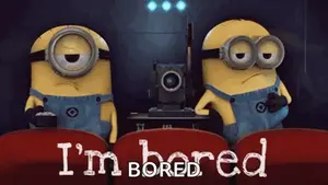 Two Minions Are Sitting In Red Seats With The Words " I 'M Bored "