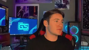 A Man Is Sitting In Front Of A Computer Monitor That Says Gamer Sleeve