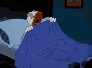 A Cartoon Character Is Laying In Bed With A Blue Blanket