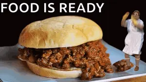 A Giant Sloppy Joe Sandwich With The Words Food Is Ready Behind It