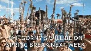 A Crowd Of People At A Beach With The Words Fyi-Gorny 'S Will Be On Spring Break Next Week On The Bottom