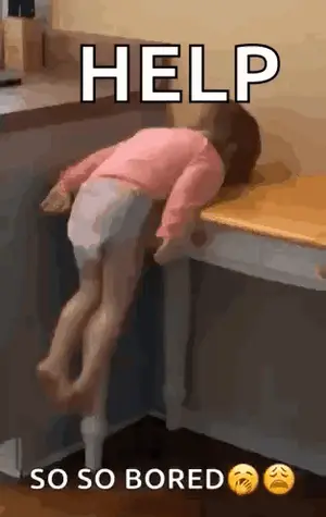 A Little Girl Is Laying On Top Of A Wooden Desk .