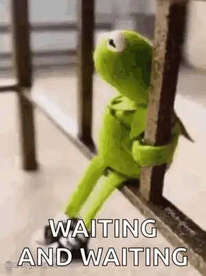 Kermit The Frog Is Sitting On A Railing Holding Onto A Railing And Waiting .