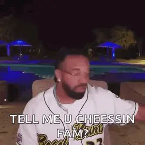 A Man With A Beard Is Sitting In Front Of A Pool And Talking To Someone .