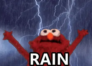 Elmo From Sesame Street Is Standing In The Rain