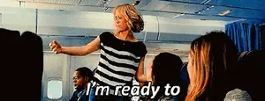 A Woman In A Striped Shirt Is Dancing On An Airplane And Says I 'M Ready To .