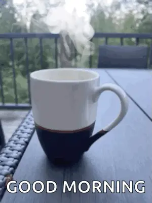 A Cup Of Coffee With Steam Coming Out Of It Is On A Table With The Words Good Morning Below It .
