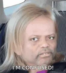 A Man With Blonde Hair And A Beard Is Sitting In A Car And Says I 'M Confused .