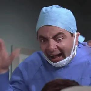 A Surgeon With A Mask On His Face Is Making A Funny Face