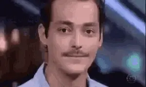 A Man With A Mustache Is Making A Funny Face While Looking At The Camera .