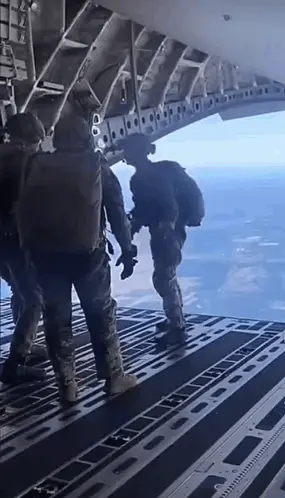 A Group Of Soldiers Are Standing On The Bottom Of A Plane