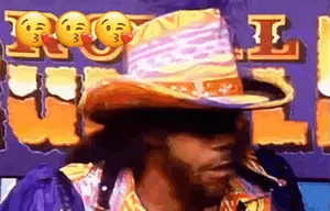 A Man Wearing A Cowboy Hat Is Standing In Front Of A Sign That Says ' I Love You '