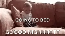 A Baby Is Sitting On A Couch With The Words `` Going To Bed '' .