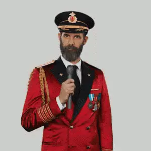 A Man With A Beard Is Wearing A Red Suit And Hat And Making A Funny Face .