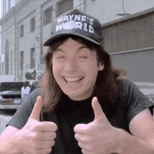 A Man Wearing A Black Hat That Says Wayne 'S World Gives Two Thumbs Up