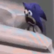 A Close Up Of A Blue Sonic The Hedgehog Standing On A Bed .