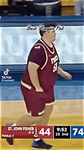 A Man In A Basketball Uniform Is Running On A Court .