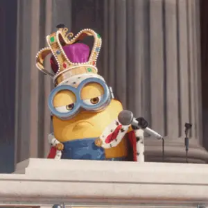 A Cartoon Minion Wearing A Crown And A King 'S Robe Is Speaking Into A Microphone