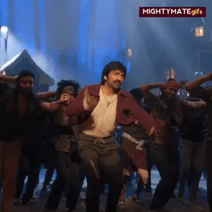 A Group Of People Are Dancing In A Dark Room With A Mightymate Gif On The Top Right