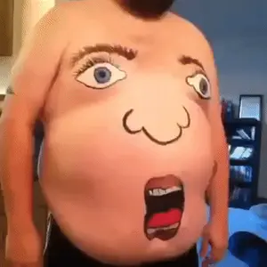 A Man With A Face Painted On His Belly